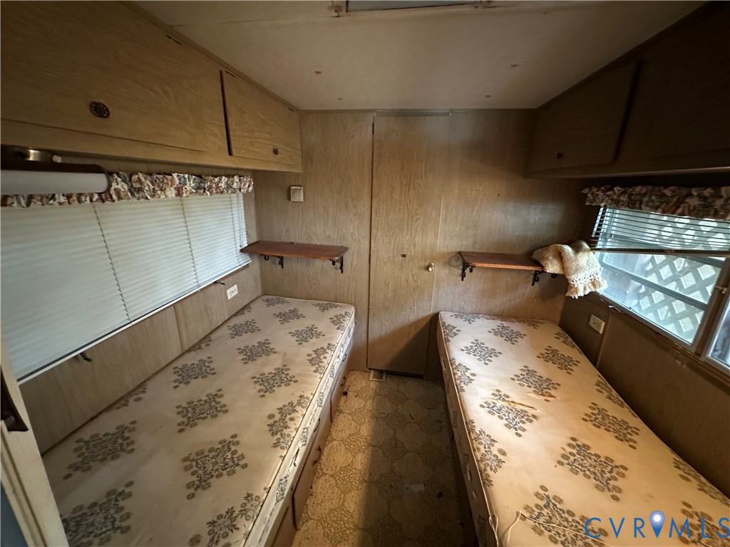 421 Happy Trail Bracey, VA 23919 - Photo 21 of 22 Unfurnished bedroom with wooden walls