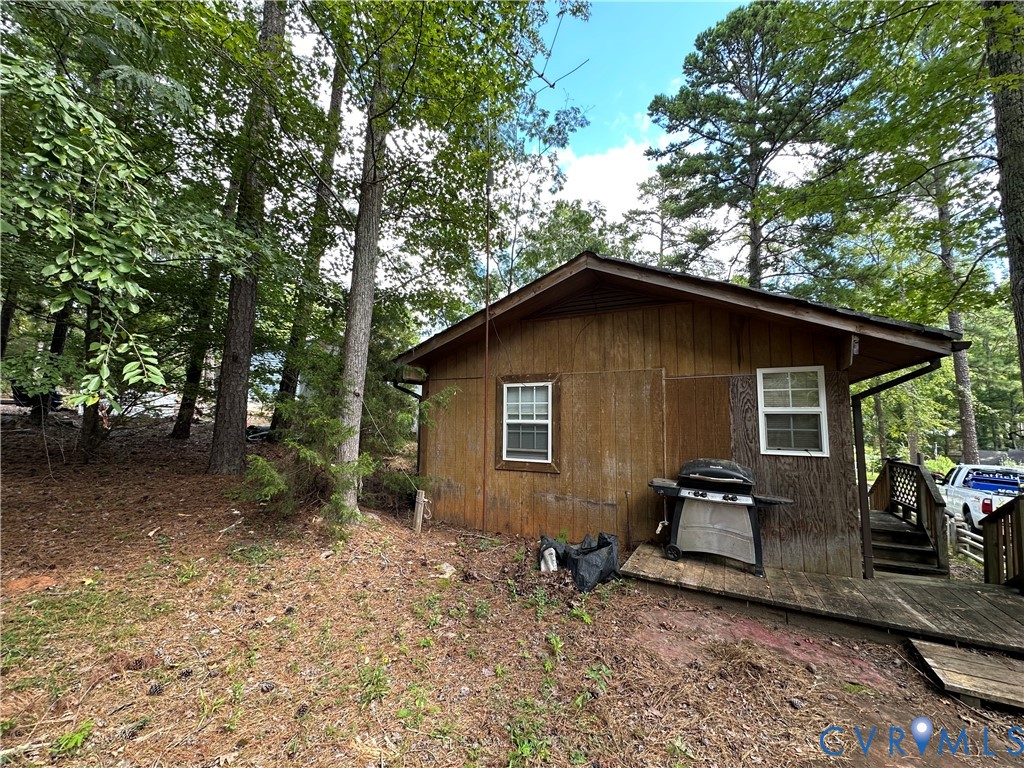 421 Happy Trail Bracey, VA 23919 - Photo 5 of 22 View of home's exterior featuring a wooden deck