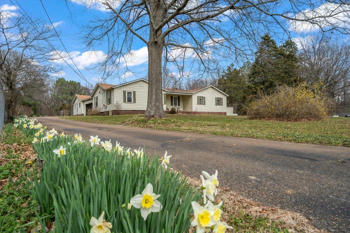 2972 Russell Bond Road Millington, TN 38053 - Photo 1 of 38 a front view of a house with a yard covered in snow