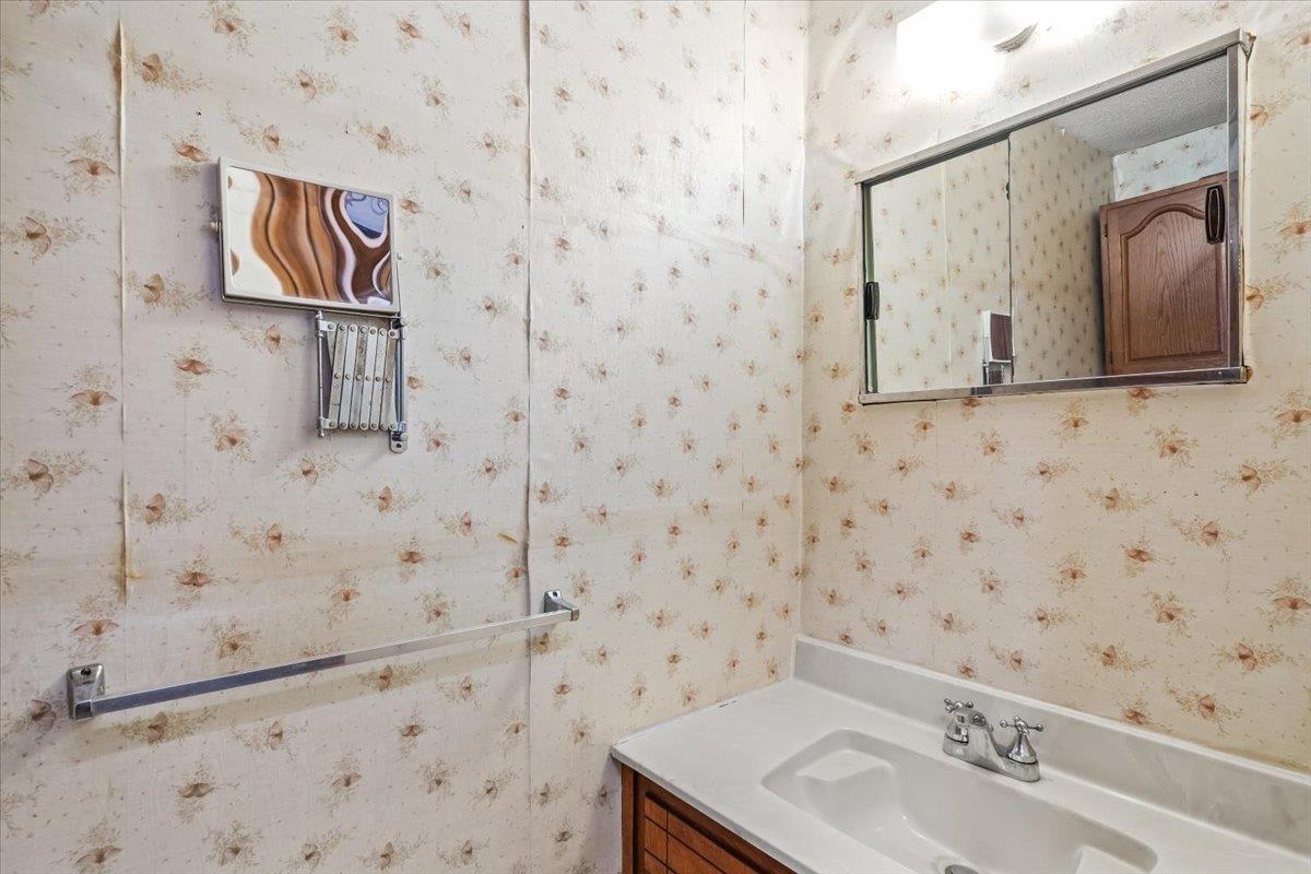2972 Russell Bond Road Millington, TN 38053 - Photo 18 of 38 1/2 Bath with vanity and wallpapered walls