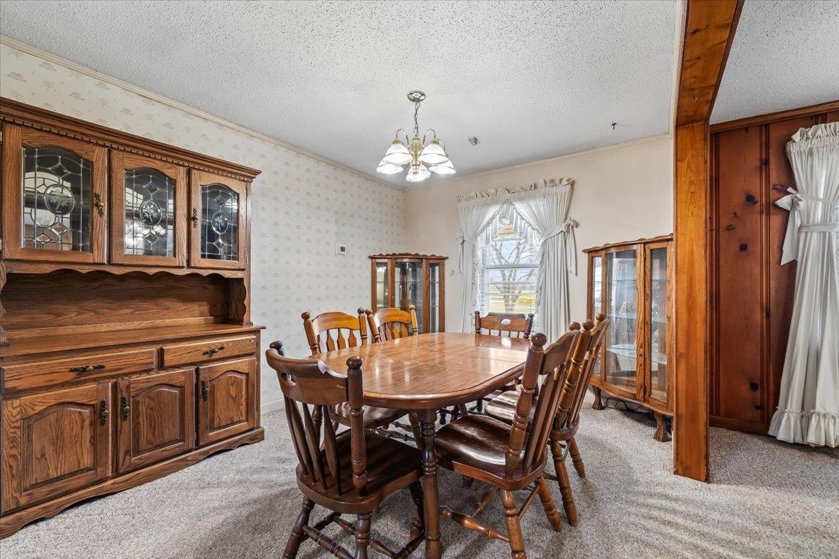 2972 Russell Bond Road Millington, TN 38053 - Photo 24 of 38 Dining space featuring light carpet, a textured ceiling, hanging lights, and ornamental molding