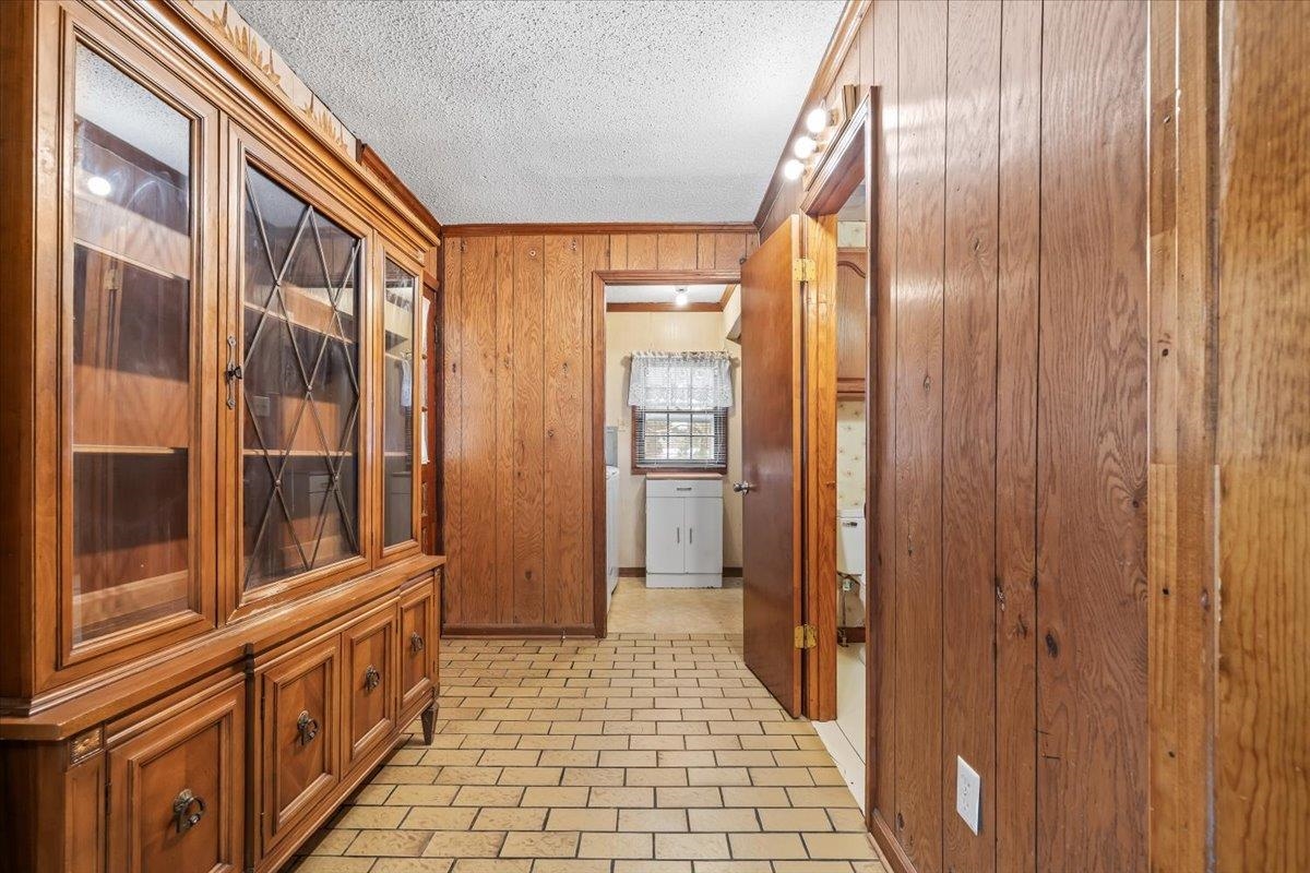 2972 Russell Bond Road Millington, TN 38053 - Photo 32 of 38 Hallway featuring wood walls, a textured ceiling, and crown molding