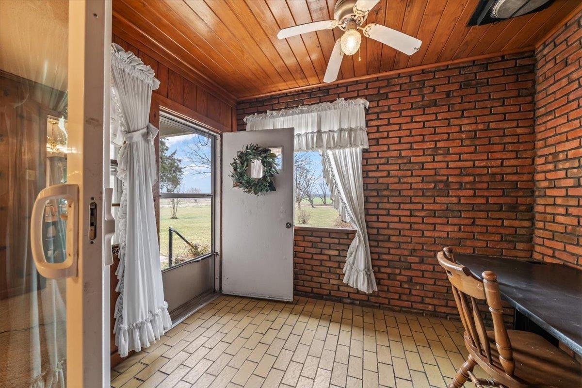 2972 Russell Bond Road Millington, TN 38053 - Photo 7 of 38 brick flooring, brick wall, wood ceiling, and a ceiling fan