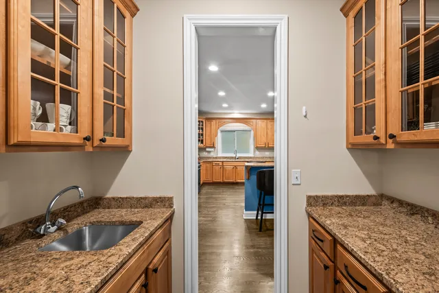 a kitchen that has a sink a stove and a oven with wooden floor