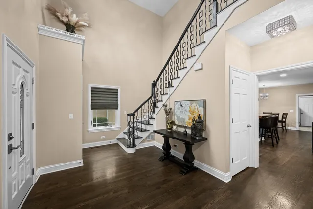 a view of an entryway with wooden floor and stairs