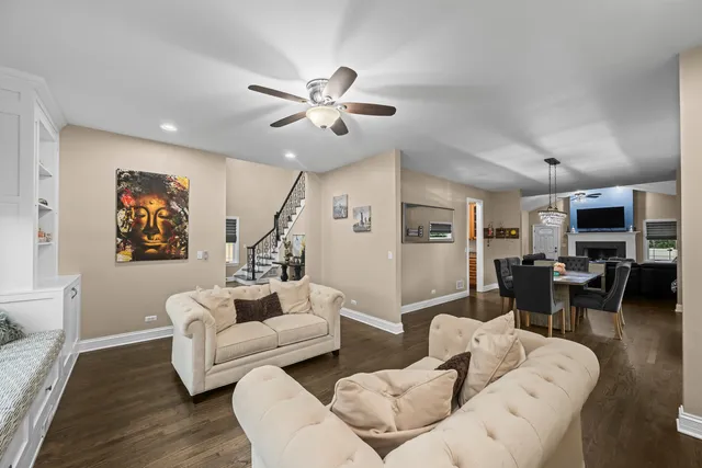 a living room with furniture and wooden floor