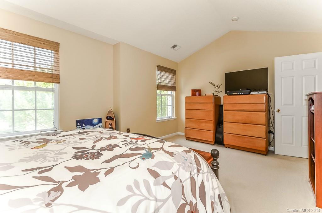 16732 Timber Crossing Road, Unit 2023 Charlotte, NC 28213 - Photo 14 of 21 a bedroom with a bed and a television