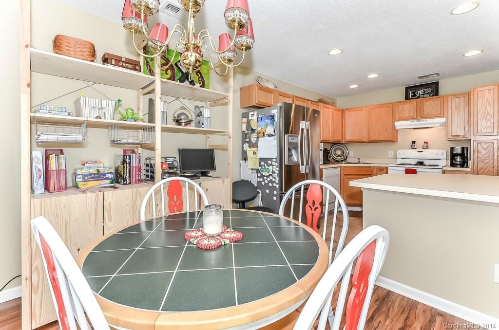 16732 Timber Crossing Road, Unit 2023 Charlotte, NC 28213 - Photo 8 of 21 a room with stainless steel appliances furniture a dining table and kitchen view