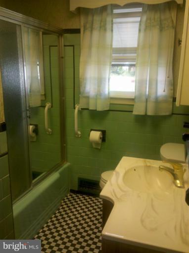 3926 North Point Road Dundalk, MD 21222 - Photo 2 of 23 a bathroom with a sink toilet and shower