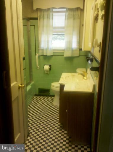 3926 North Point Road Dundalk, MD 21222 - Photo 17 of 23 a bathroom with a sink a toilet and mirror