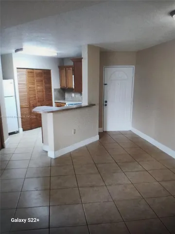 a view of kitchen with granite countertop cabinets