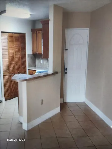 a view of kitchen with granite countertop cabinets