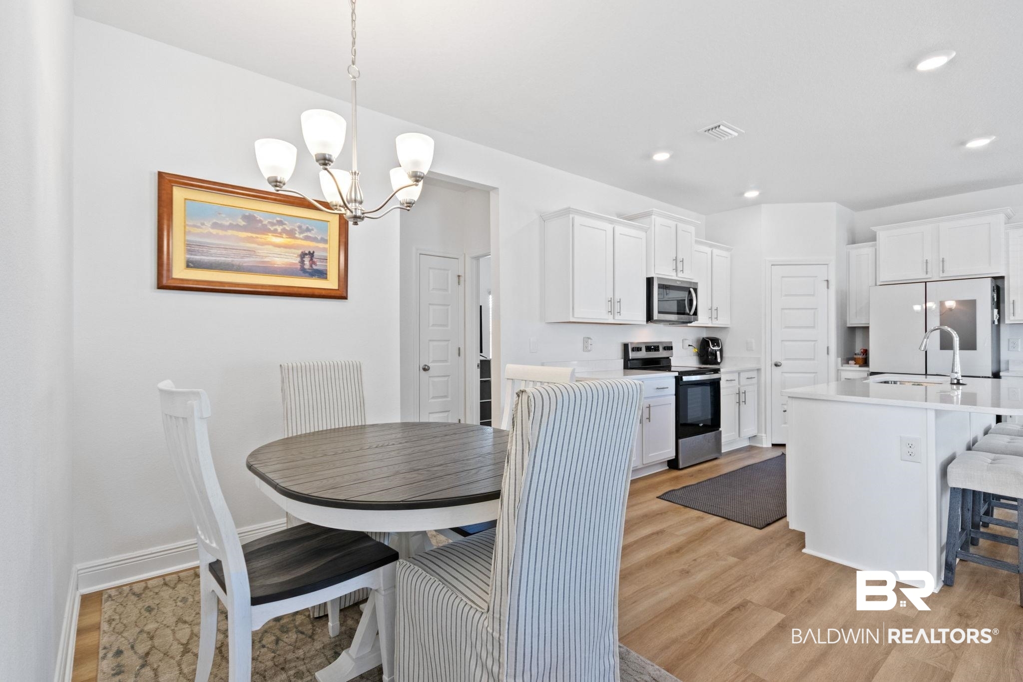 12919 Torrent Road Fairhope, AL 36532 - Photo 28 of 74 Dining space with light wood-style floors and a chandelier
