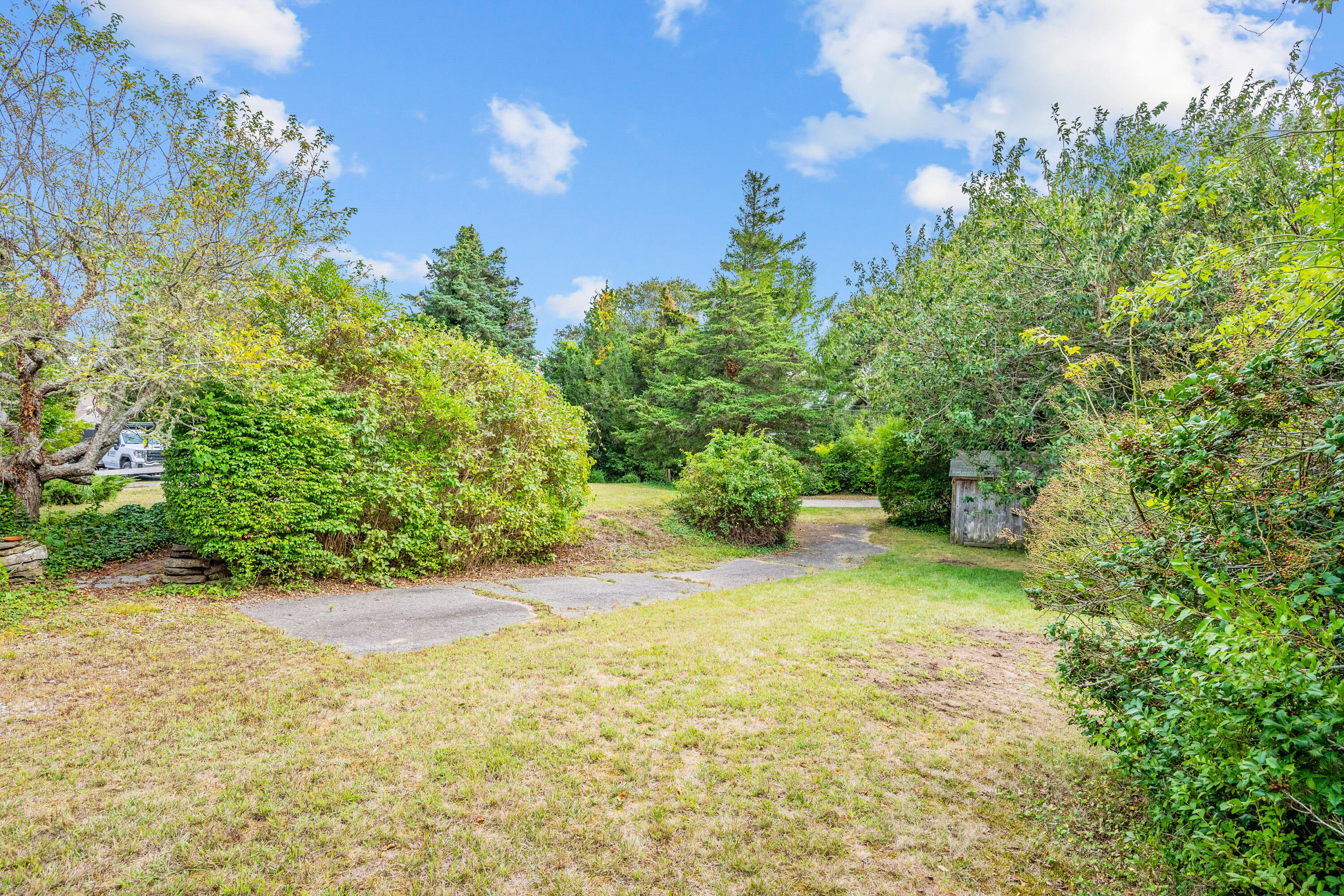 33 Mill Pond Road Orleans, MA 02653 - Photo 12 of 50 a view of a yard with an trees