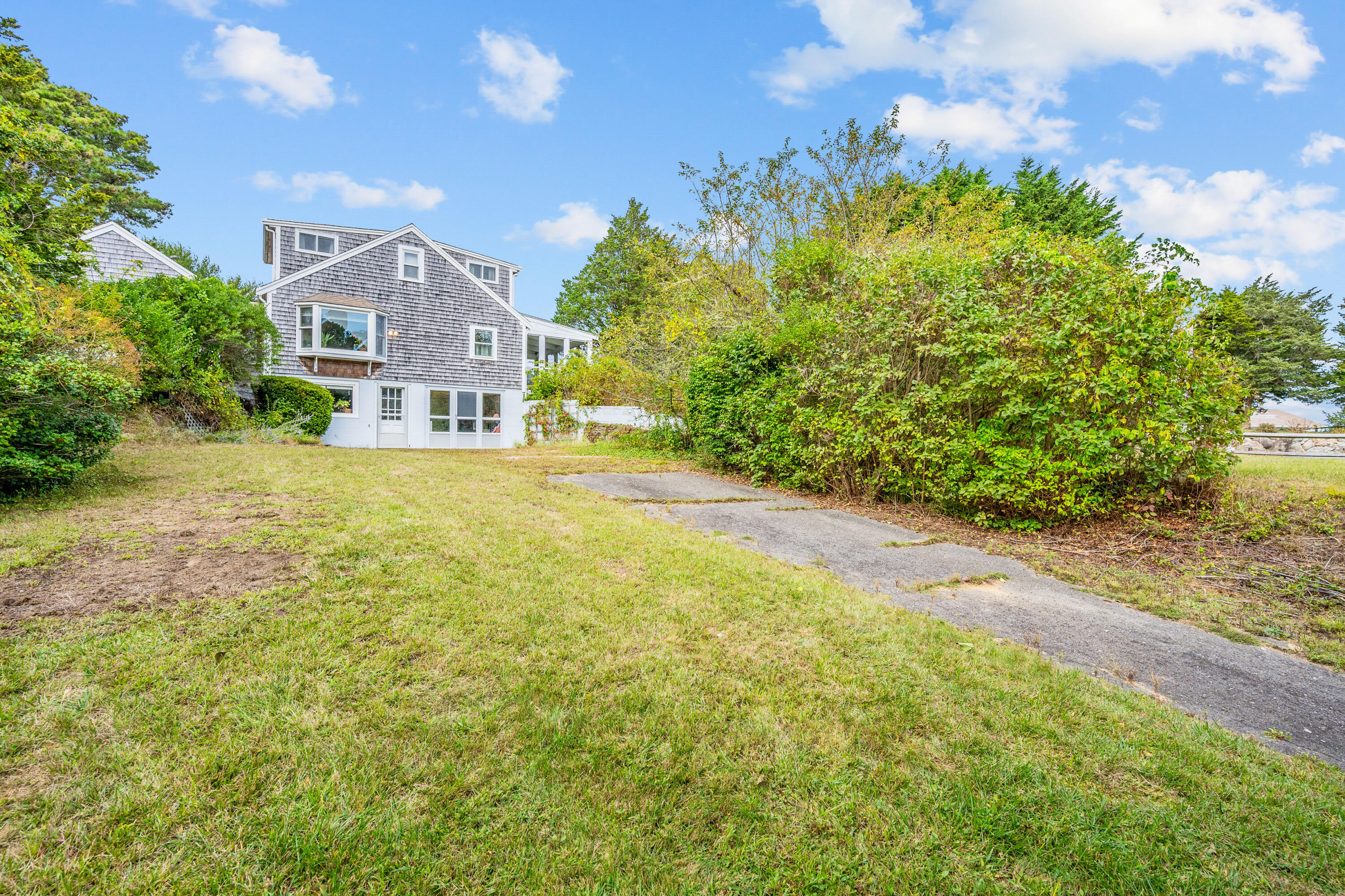 33 Mill Pond Road Orleans, MA 02653 - Photo 14 of 50 a front view of a house with a yard