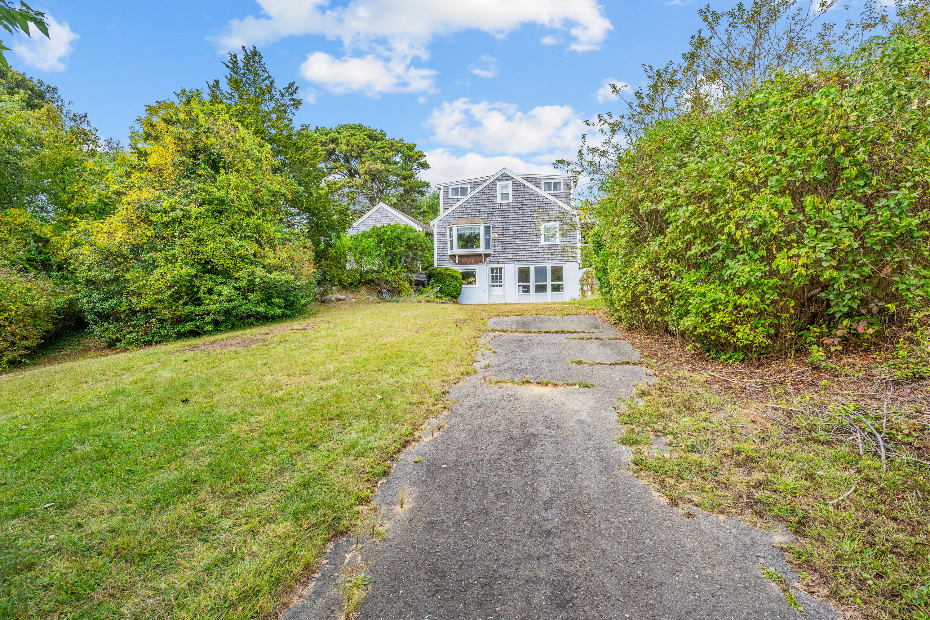 33 Mill Pond Road Orleans, MA 02653 - Photo 15 of 50 a view of a big house with a big yard and large trees