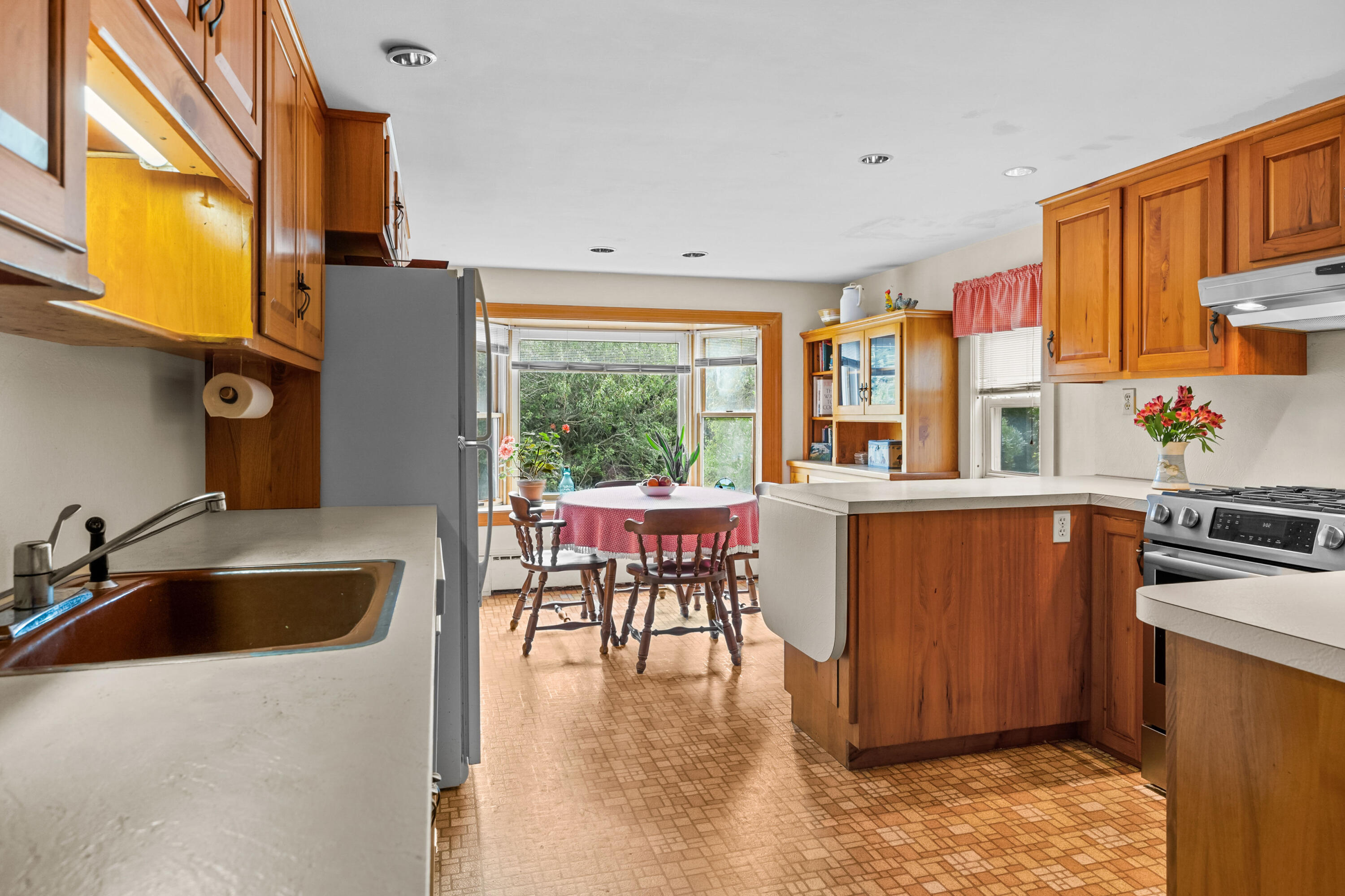33 Mill Pond Road Orleans, MA 02653 - Photo 20 of 50 a kitchen with sink a refrigerator and chairs