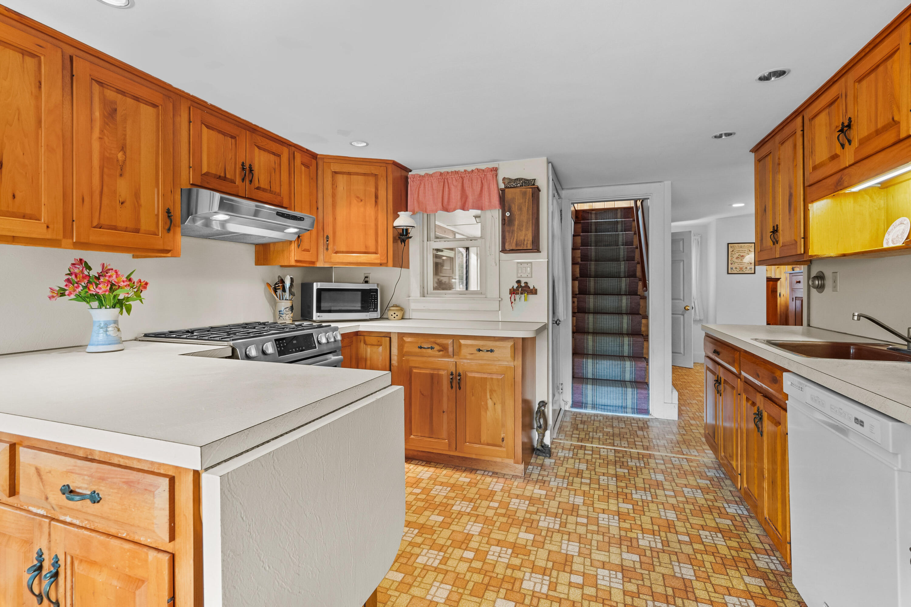 33 Mill Pond Road Orleans, MA 02653 - Photo 22 of 50 a kitchen with stainless steel appliances granite countertop a stove a sink and a refrigerator