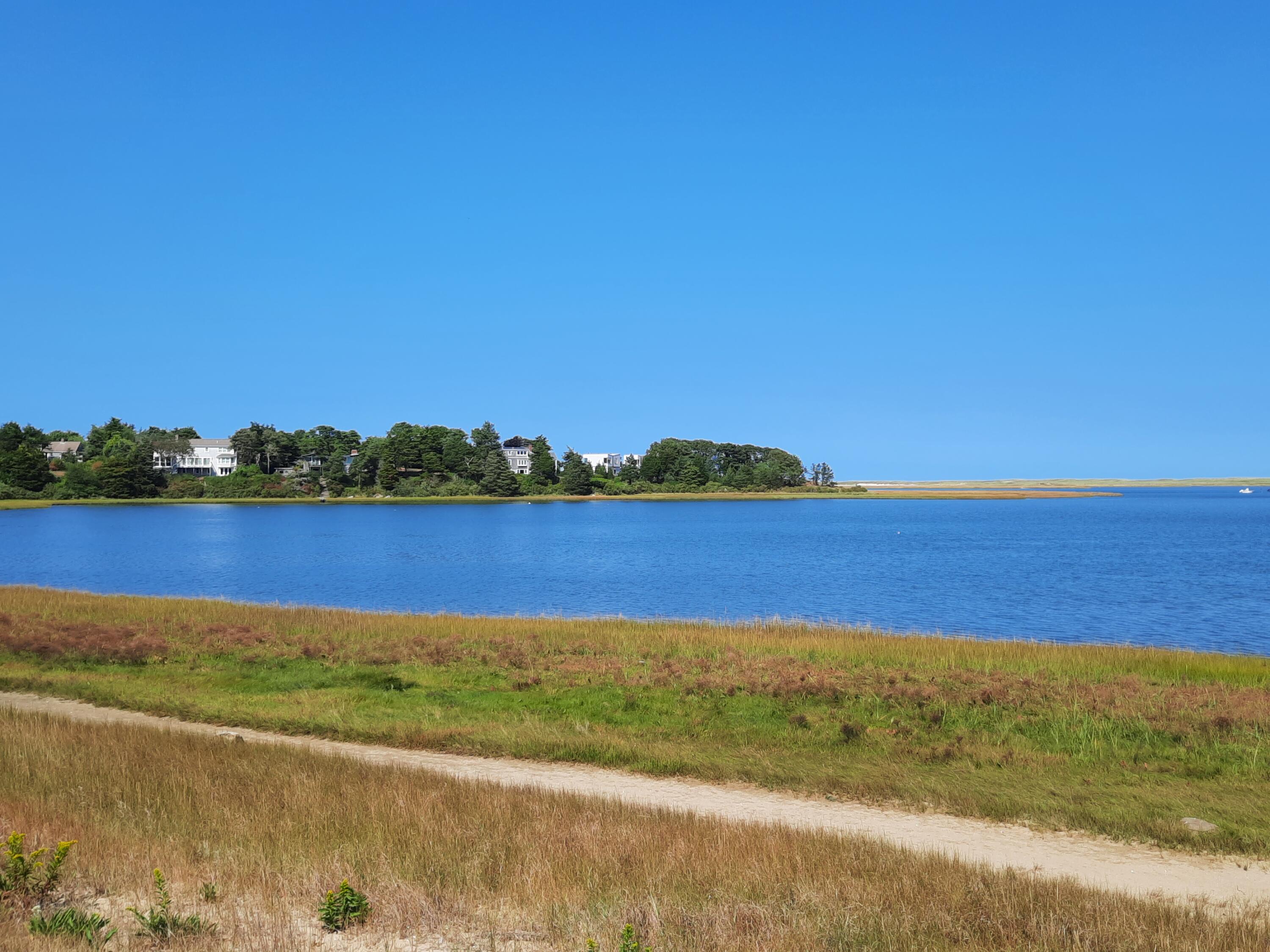 33 Mill Pond Road Orleans, MA 02653 - Photo 46 of 50 a view of a lake with houses in the back