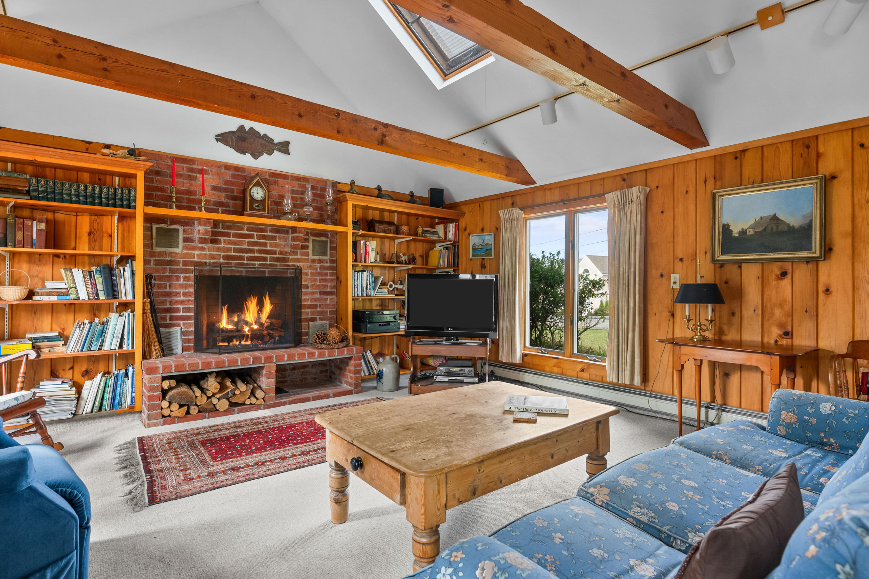 33 Mill Pond Road Orleans, MA 02653 - Photo 5 of 50 a living room with furniture a flat screen tv and a fireplace