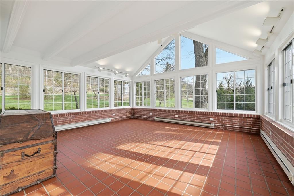 1001 Fox Chapel Road Pittsburgh, PA 15238 - Photo 28 of 50 Sunroom with vaulted ceiling and walls of windows. Door to patio.