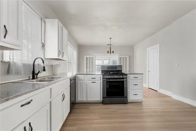 a kitchen with stainless steel appliances a sink stove and refrigerator