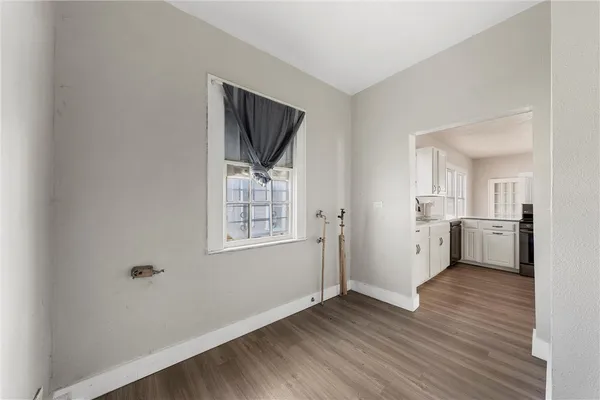a view of a kitchen with wooden floor and a sink
