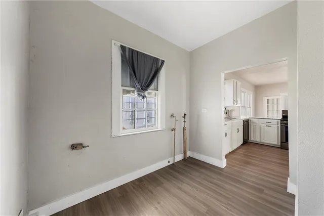 a view of a kitchen with wooden floor and a sink