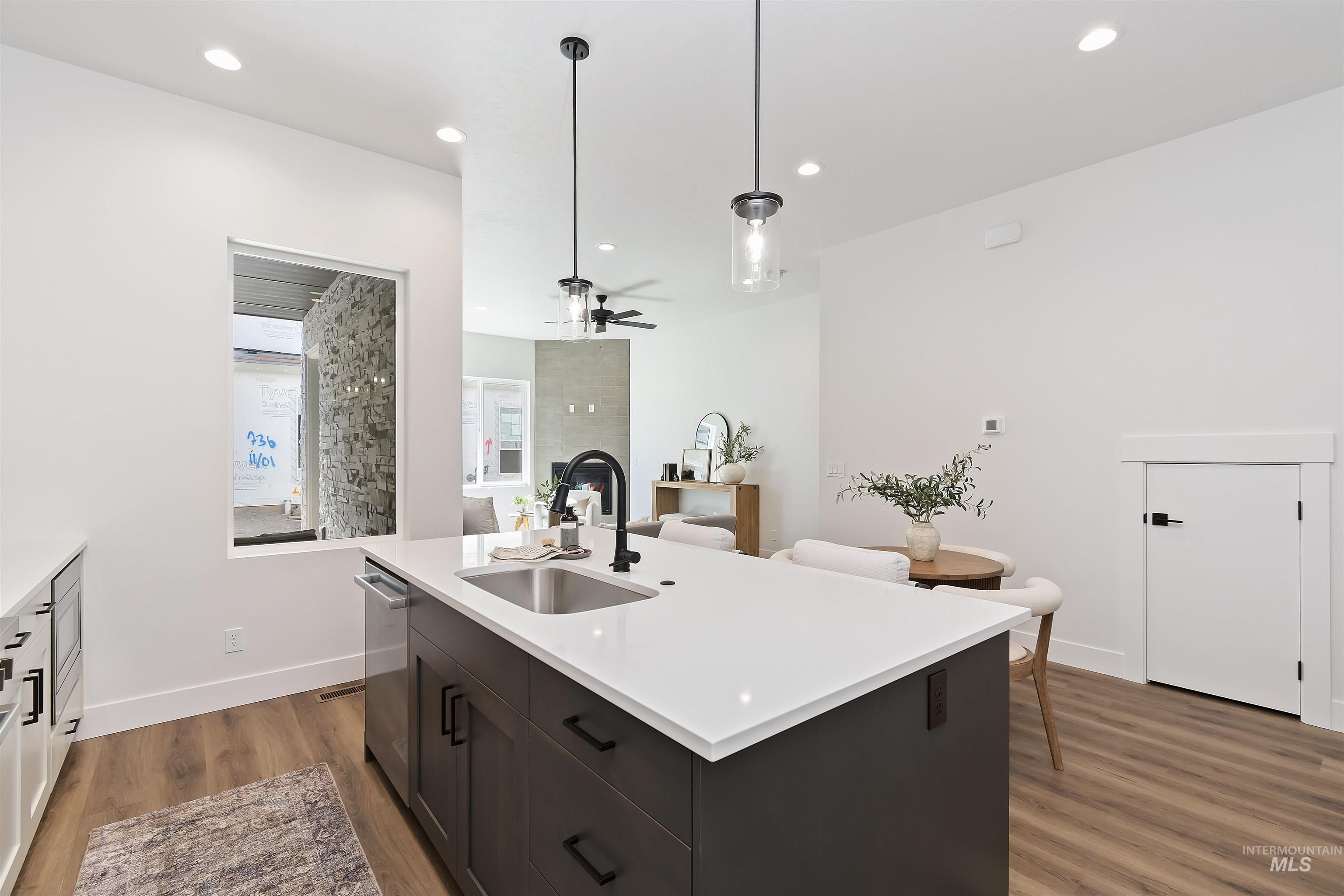 724 South Calhoun Lane Star, ID 83669 - Photo 14 of 44 Kitchen with dark wood-style flooring, hanging light fixtures, a kitchen island with sink, ceiling fan, and recessed lighting