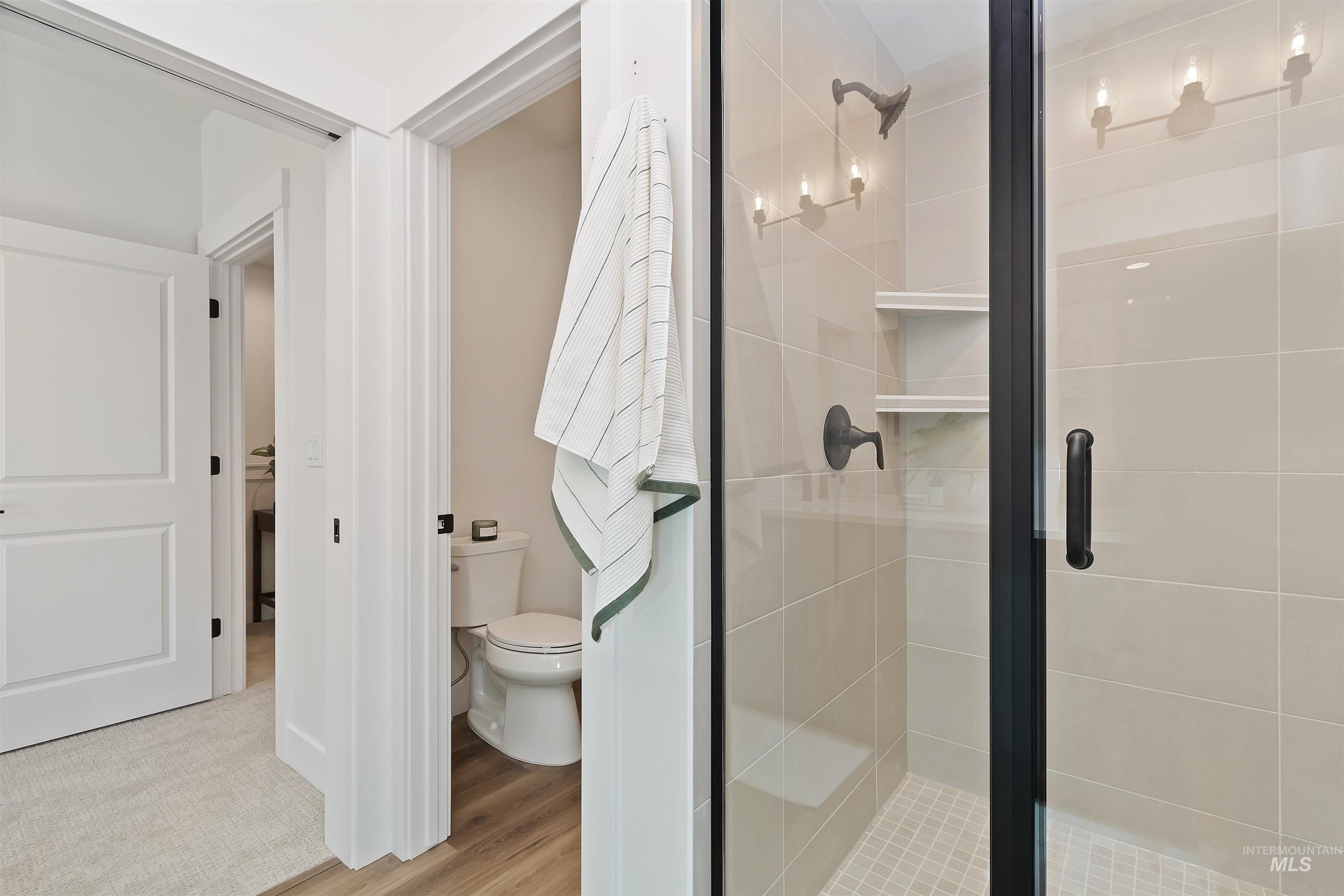 724 South Calhoun Lane Star, ID 83669 - Photo 21 of 44 Bathroom featuring a shower stall and light wood-type flooring
