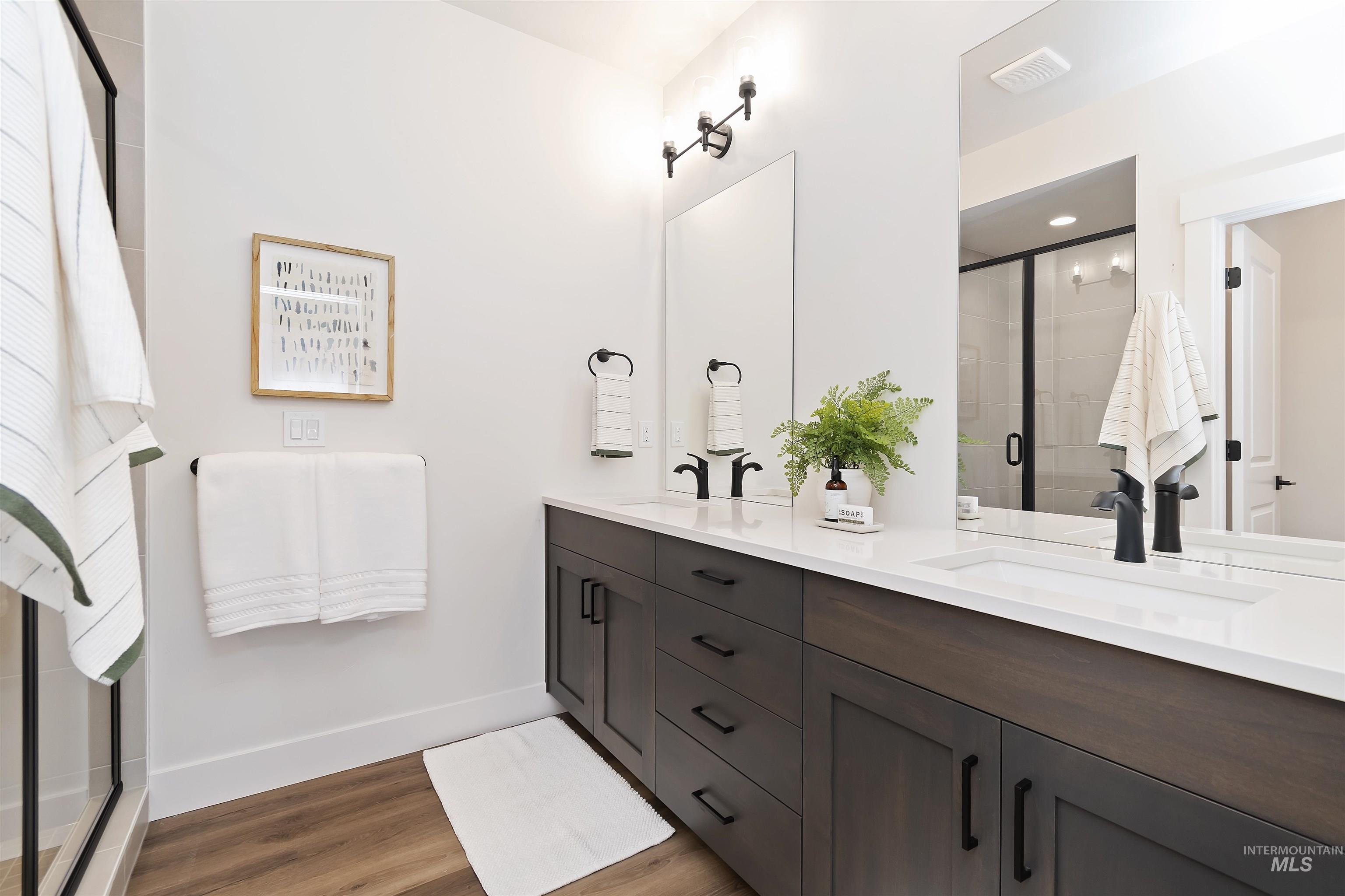 724 South Calhoun Lane Star, ID 83669 - Photo 25 of 46 Bathroom with a stall shower, double vanity, and light wood-type flooring