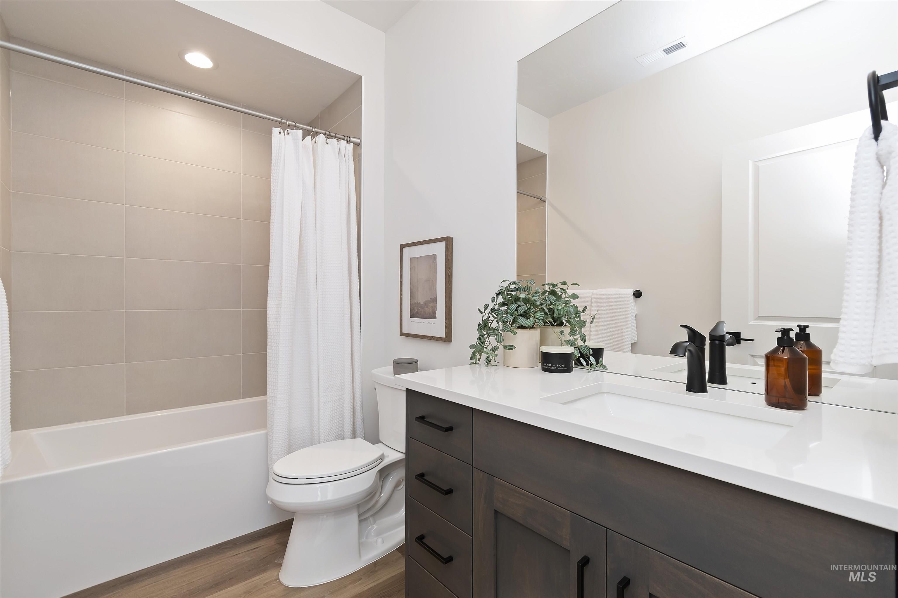 724 South Calhoun Lane Star, ID 83669 - Photo 31 of 46 Full bath featuring shower / tub combo with curtain, vanity, dark wood-style flooring, and recessed lighting