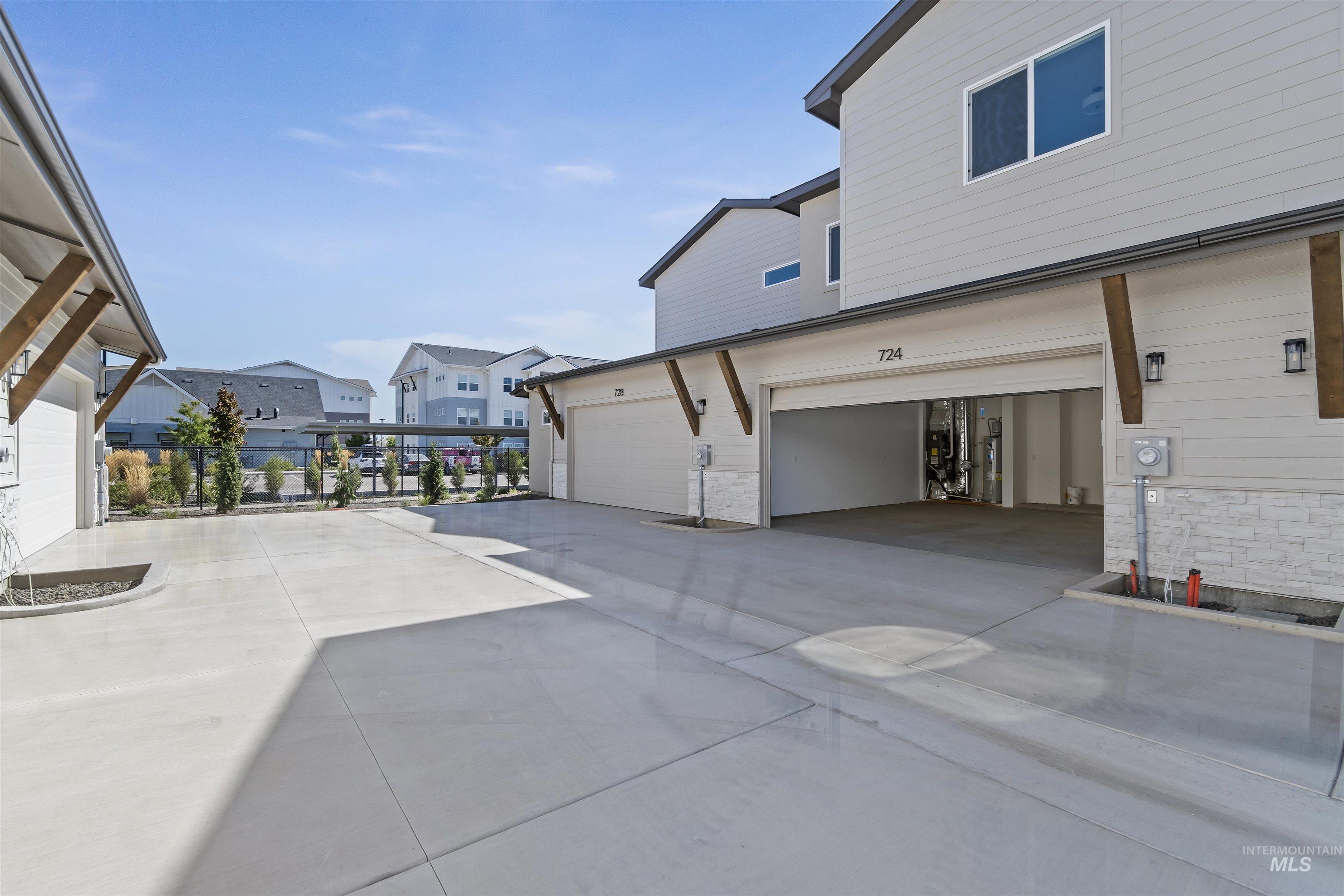 724 South Calhoun Lane Star, ID 83669 - Photo 37 of 46 View of patio / terrace with driveway, a residential view, and an attached garage