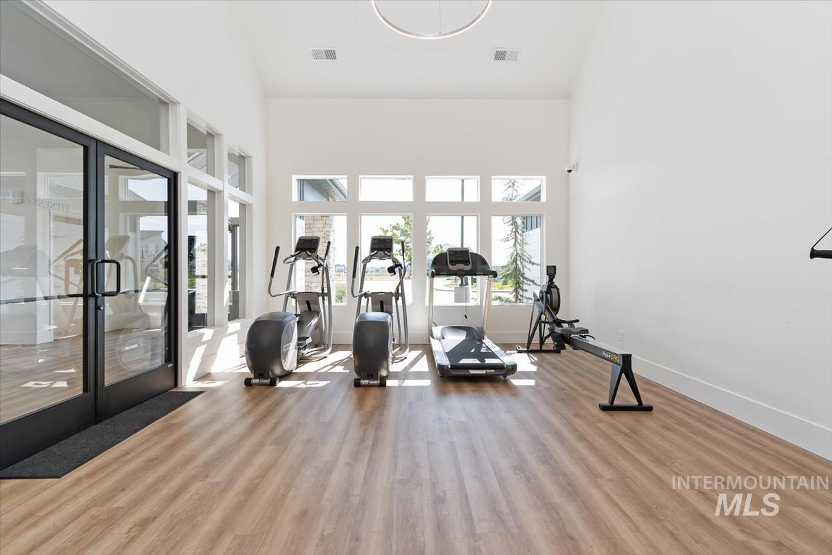 724 South Calhoun Lane Star, ID 83669 - Photo 42 of 46 Workout room featuring light wood-type flooring, a towering ceiling, and french doors