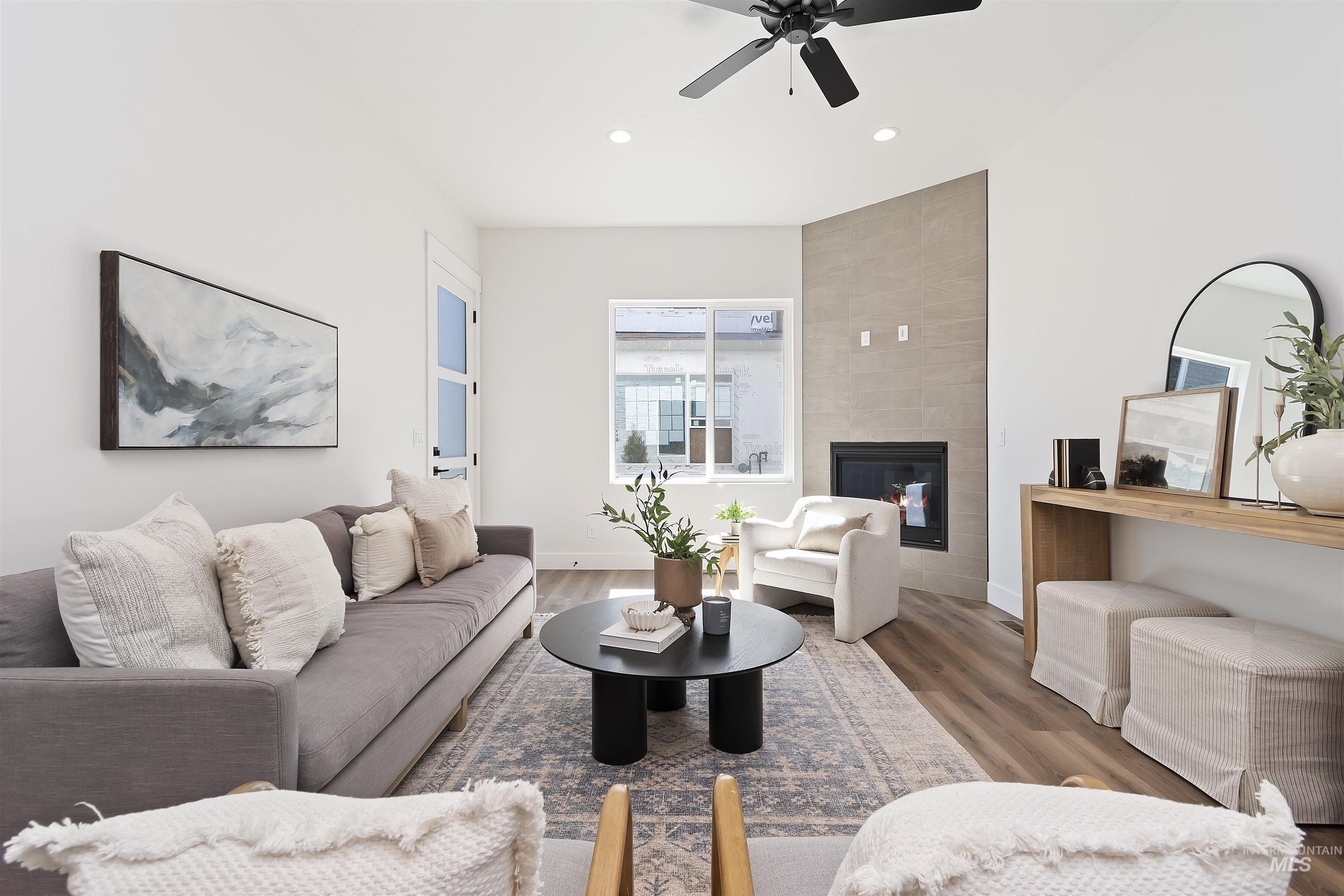 724 South Calhoun Lane Star, ID 83669 - Photo 10 of 46 Living room featuring a tile fireplace, wood finished floors, recessed lighting, and ceiling fan