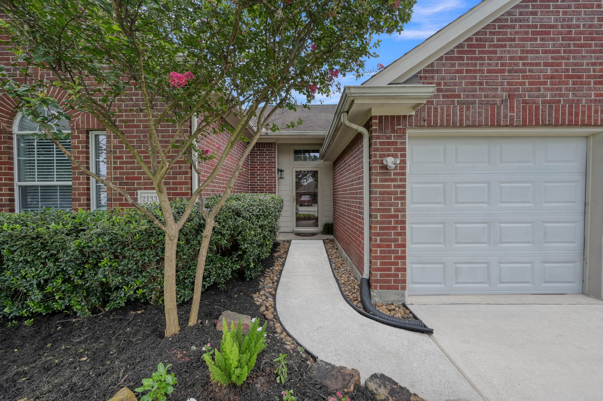 21331 Timber Pines Drive Spring, TX 77388 - Photo 2 of 22 This property offers great curb appeal with mature trees and lush landscaping that adorn a winding sidewalk that leads up to the front porch. A storm door offers you a chance to open the door and let the light in with added security too!