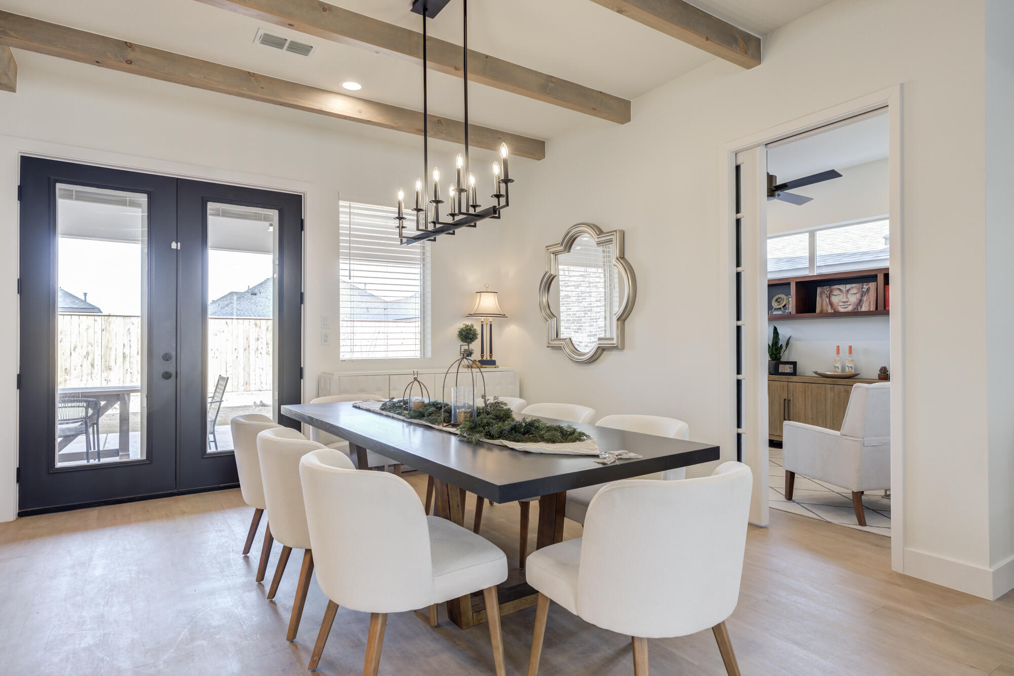 3606 144th Street Lubbock, TX 79423 - Photo 13 of 67 a view of a dining room with furniture large windows a chandelier and wooden floor