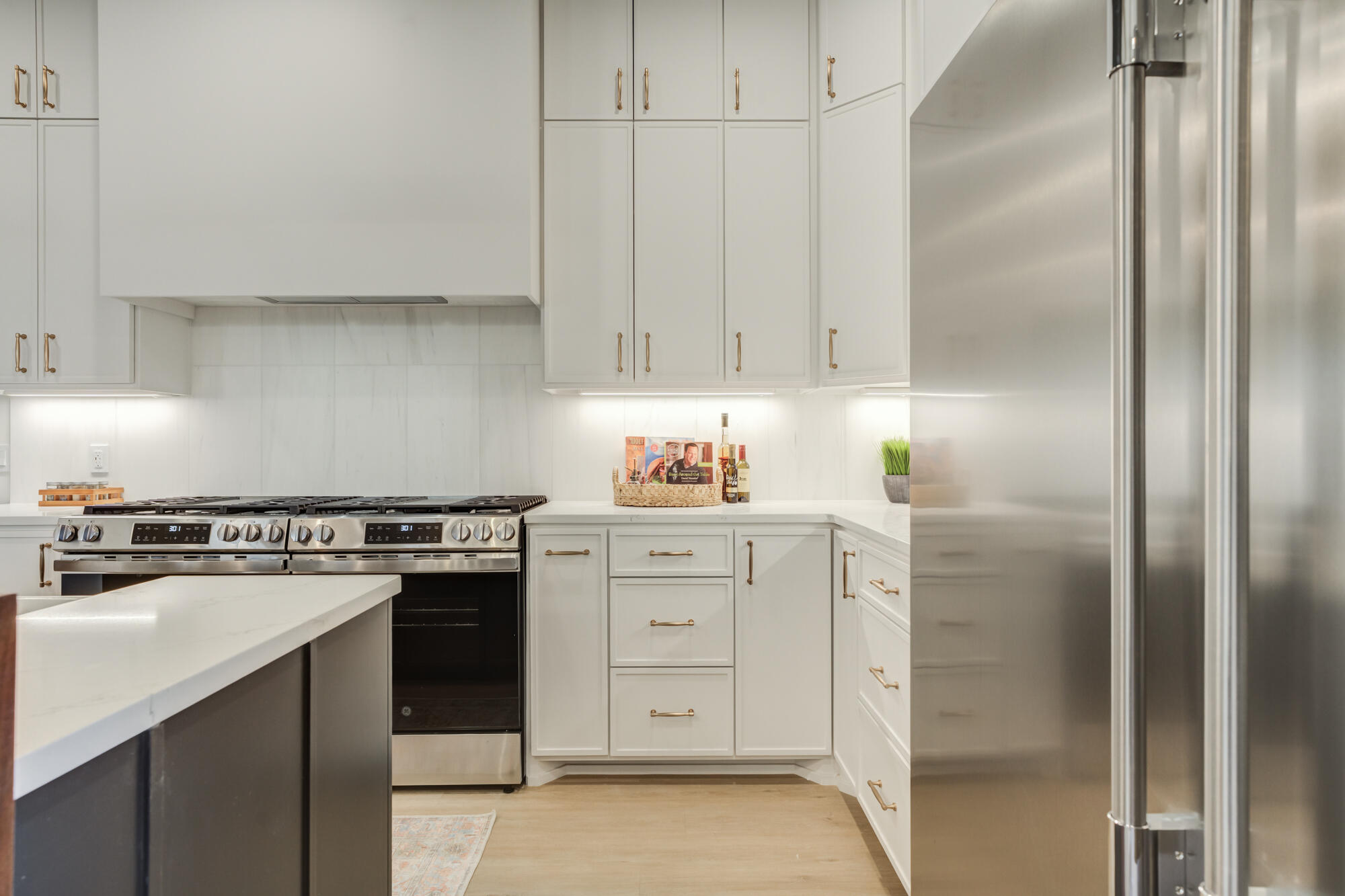 3606 144th Street Lubbock, TX 79423 - Photo 23 of 67 a kitchen with white cabinets and white appliances
