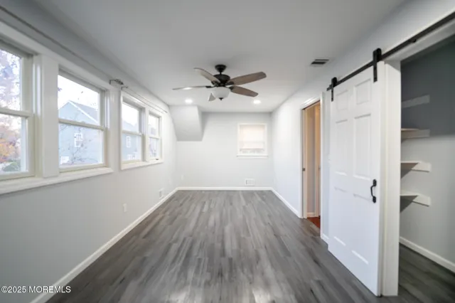 a view of walk in closet with empty racks
