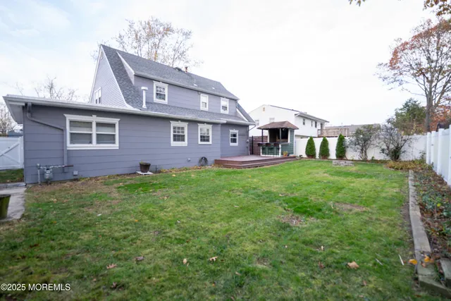 front view of a brick house with a yard