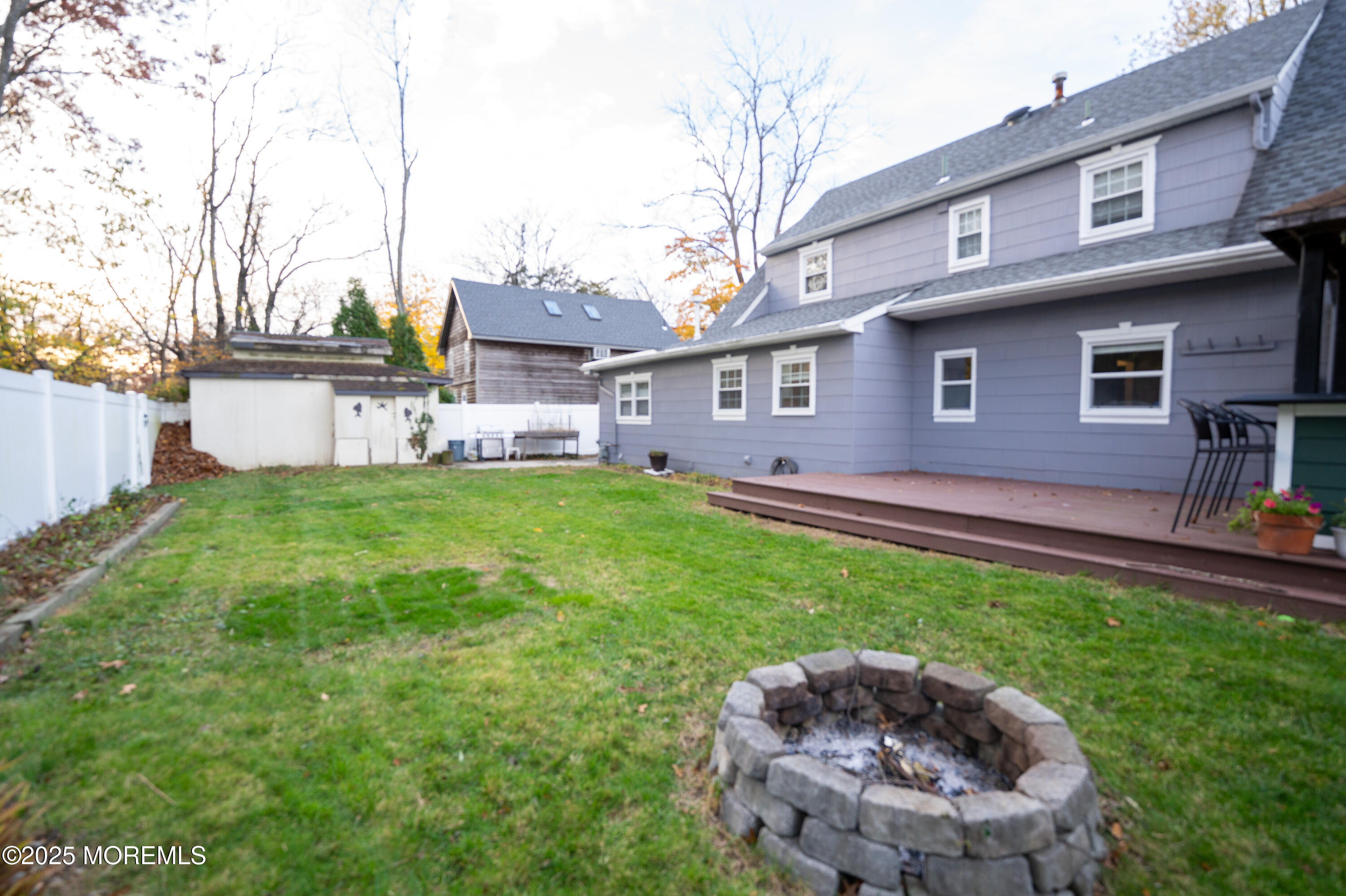 813 Raleigh Drive Toms River, NJ 08753 - Photo 20 of 28 a backyard of a house with table and chairs