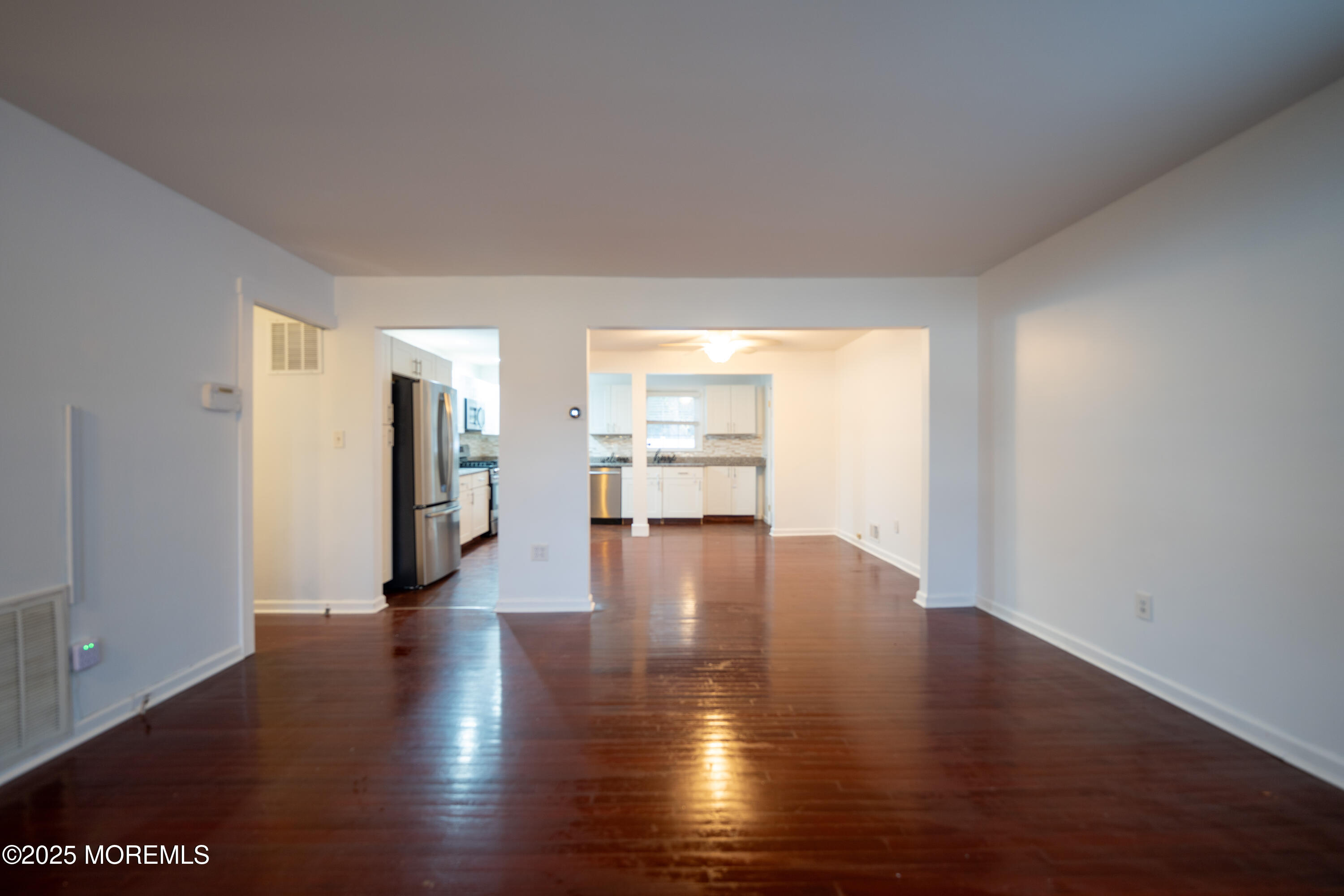 813 Raleigh Drive Toms River, NJ 08753 - Photo 4 of 28 a view of a room with wooden floor and a kitchen
