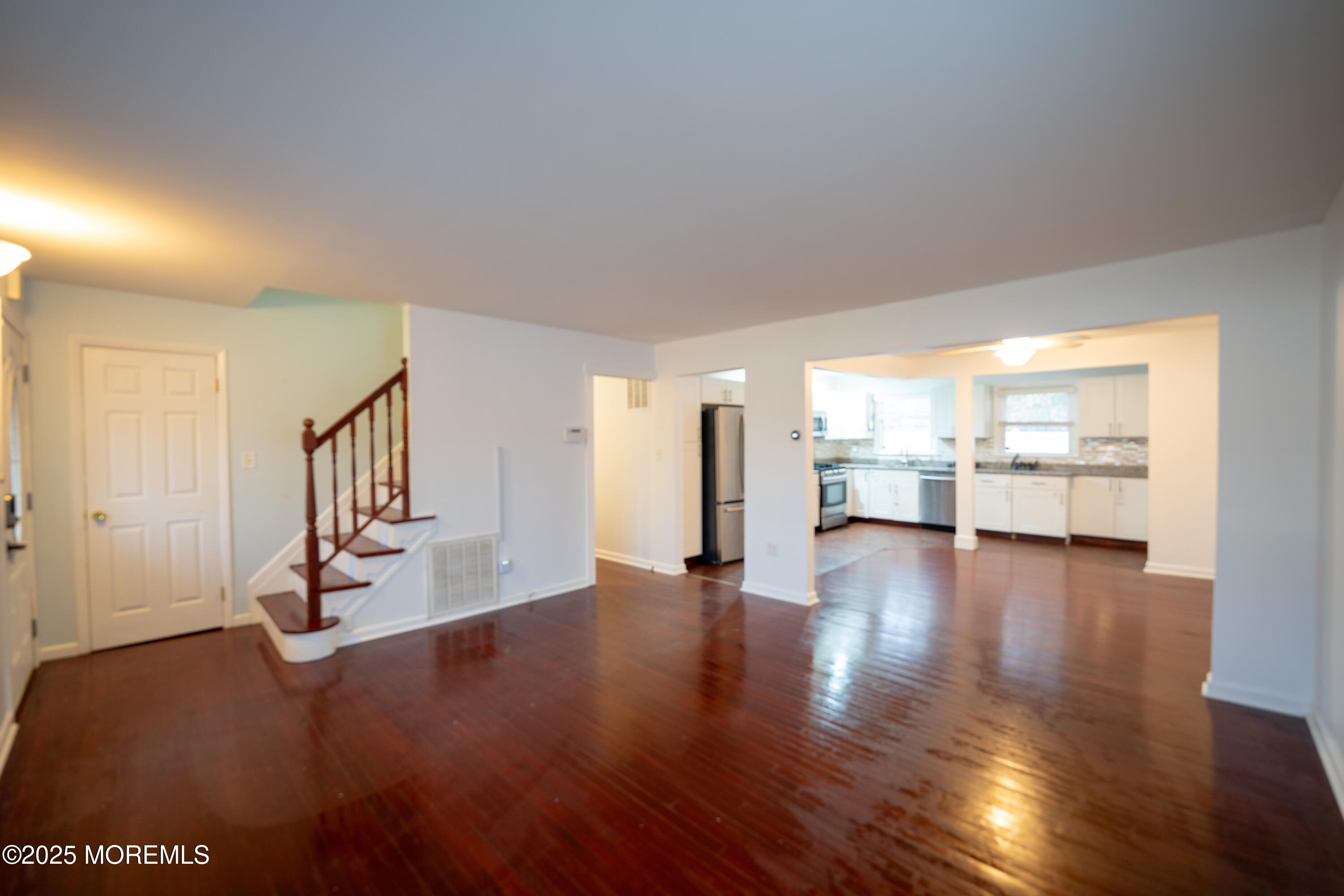 813 Raleigh Drive Toms River, NJ 08753 - Photo 5 of 28 a view of an empty room with wooden floor and windows