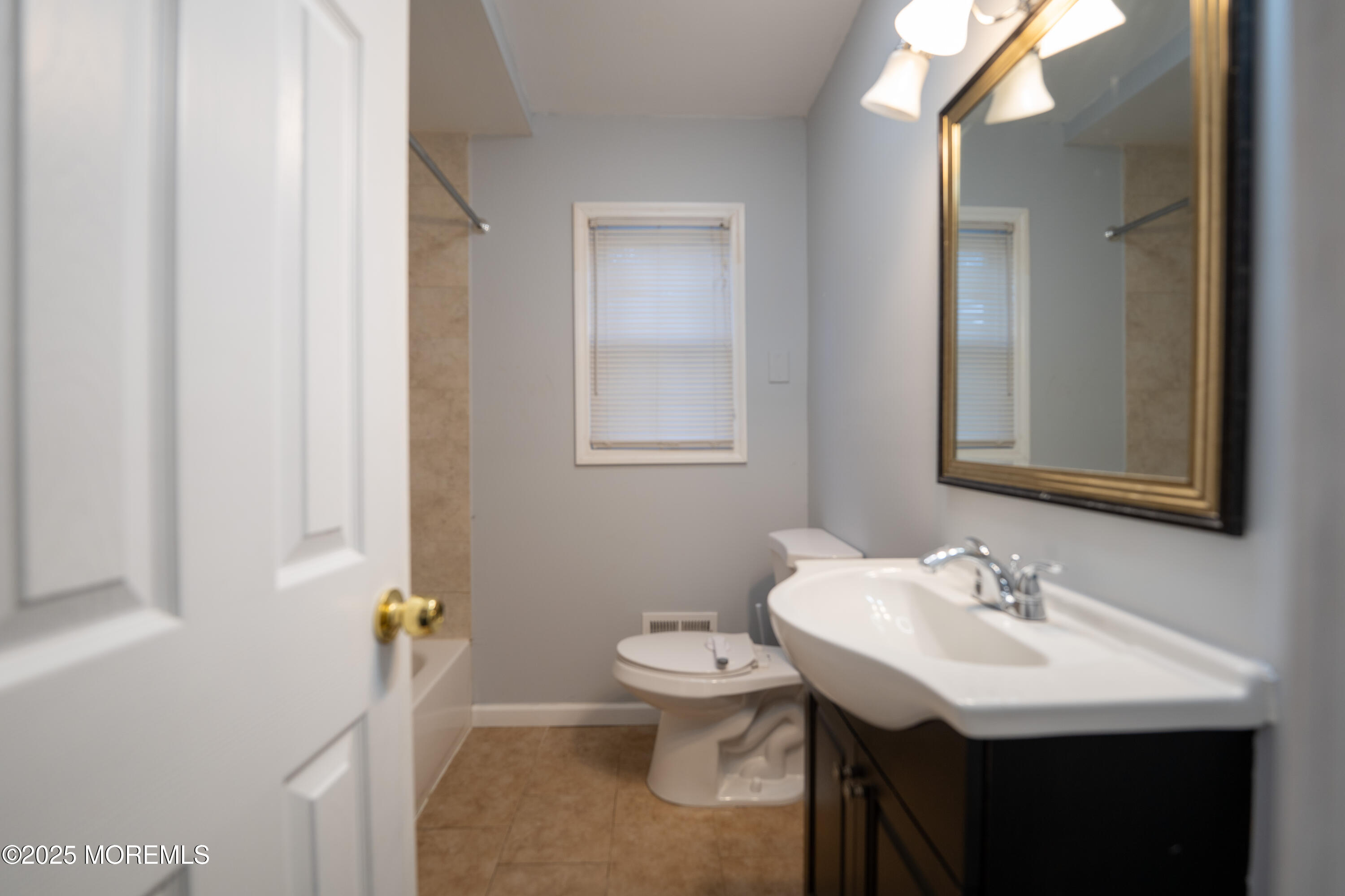 813 Raleigh Drive Toms River, NJ 08753 - Photo 8 of 28 a bathroom with a sink toilet and a mirror