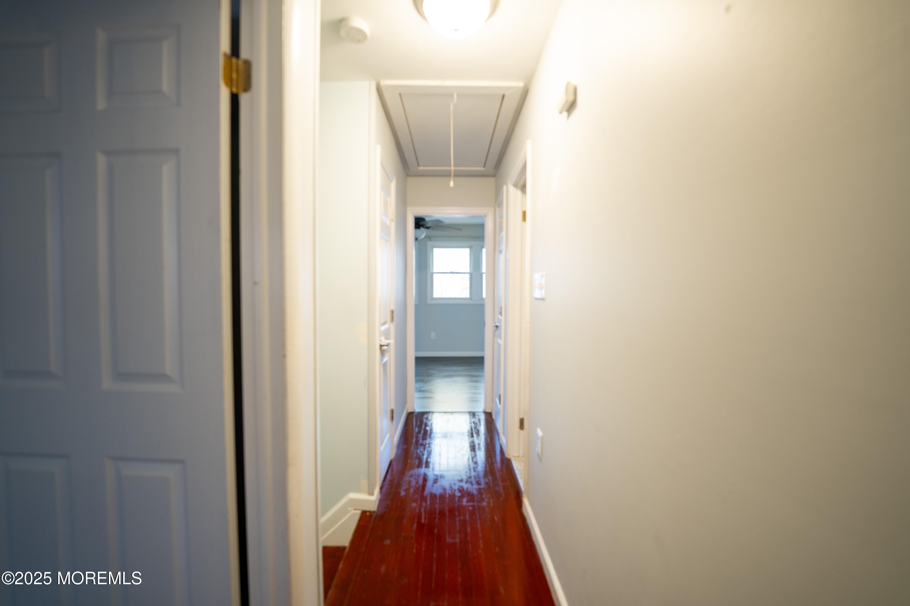 813 Raleigh Drive Toms River, NJ 08753 - Photo 10 of 28 a view of a hallway with wooden floor