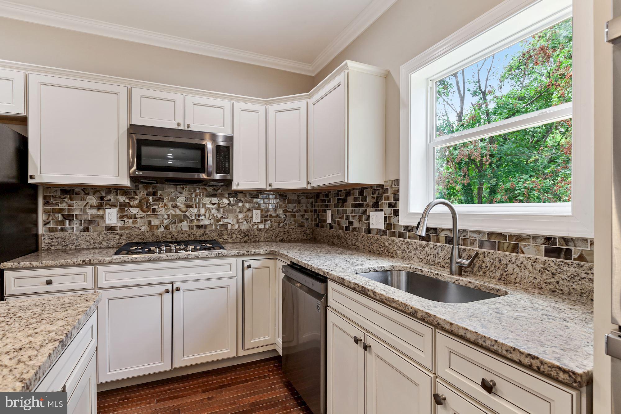 32 Kingsley Road Owings Mills, MD 21117 - Photo 9 of 29 Granite countertops & decorative tile backsplash