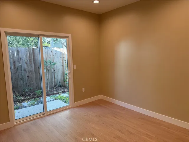 a view of a room with wooden floor and windows