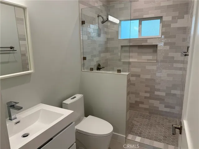a bathroom with a sink mirror and toilet