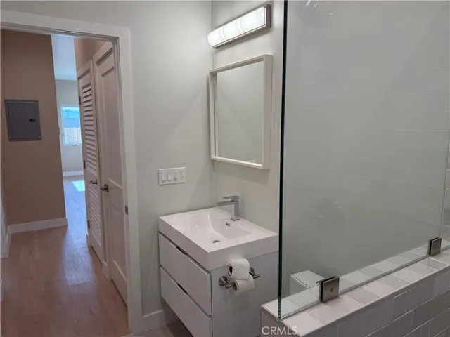 a bathroom with a sink mirror and vanity