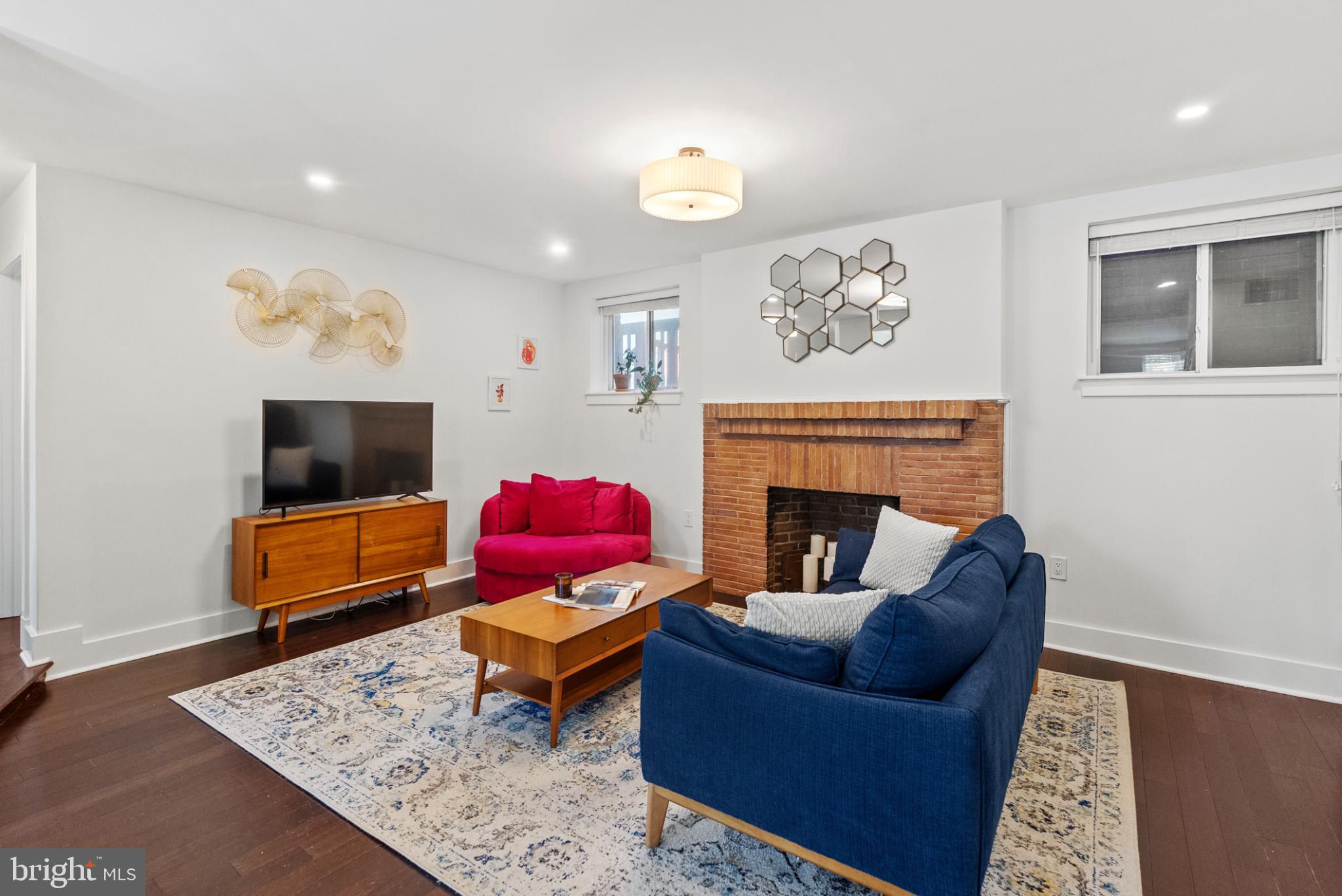 1461 Girard Street Northwest, Unit 201 Washington, DC 20009 - Photo 12 of 24 a living room with furniture and a fireplace
